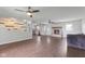 Open-concept living room with a fireplace, ceiling fans, and modern flooring at 522 E County Road 1000 S, Clayton, IN 46118