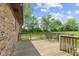 Wooden patio with railing next to the brick house overlooking the green lawn at 522 E County Road 1000 S, Clayton, IN 46118