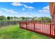 Backyard deck with wood railings with a partial view of the backyard and neighborhood at 5305 Adrian Orchard Dr, Indianapolis, IN 46217