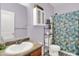 This bathroom has a vanity sink, shelving, and a tub with a shower curtain at 5305 Adrian Orchard Dr, Indianapolis, IN 46217