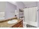 This bathroom has a vanity sink, a tub with a shower curtain, and patterned floors at 5305 Adrian Orchard Dr, Indianapolis, IN 46217