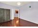 Bedroom showcasing wood floors, a stylish fixture, and an open doorway at 5305 Adrian Orchard Dr, Indianapolis, IN 46217