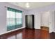 Bedroom featuring wood floors, a large window, and a wardrobe at 5305 Adrian Orchard Dr, Indianapolis, IN 46217