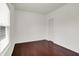 This is a bedroom featuring hardwood floors, a door, and a window at 5305 Adrian Orchard Dr, Indianapolis, IN 46217
