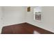 This is a bedroom with wood flooring, a window, and white walls at 5305 Adrian Orchard Dr, Indianapolis, IN 46217