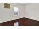 This bedroom has hardwood floors, a window, and white walls at 5305 Adrian Orchard Dr, Indianapolis, IN 46217
