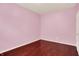 This bedroom has a light pink color scheme and beautiful hardwood floors at 5305 Adrian Orchard Dr, Indianapolis, IN 46217
