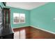 This bedroom is well-lit by a window and features beautiful hardwood floors at 5305 Adrian Orchard Dr, Indianapolis, IN 46217