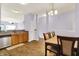 Open-concept dining area with a table, wood floors, and kitchen access at 5305 Adrian Orchard Dr, Indianapolis, IN 46217