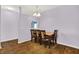 Bright dining area with a table set for six and stylish laminate flooring at 5305 Adrian Orchard Dr, Indianapolis, IN 46217