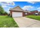 Well-maintained single-story brick home with attached two-car garage at 5305 Adrian Orchard Dr, Indianapolis, IN 46217