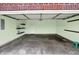 This garage features a green paint job, shelves, and a cement floor at 5305 Adrian Orchard Dr, Indianapolis, IN 46217