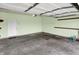 This is a green painted garage featuring a concrete floor and some shelves at 5305 Adrian Orchard Dr, Indianapolis, IN 46217