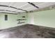 A garage featuring a painted interior, shelves, and a concrete floor at 5305 Adrian Orchard Dr, Indianapolis, IN 46217