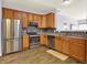 Bright kitchen with stainless steel appliances and wooden cabinets with tile backsplash at 5305 Adrian Orchard Dr, Indianapolis, IN 46217