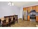 Bright eat-in kitchen features stainless steel appliances, tile backsplash and wooden cabinets at 5305 Adrian Orchard Dr, Indianapolis, IN 46217