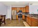 Bright kitchen features stainless steel appliances, tile backsplash and wooden cabinets at 5305 Adrian Orchard Dr, Indianapolis, IN 46217