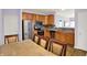 Bright kitchen with stainless steel appliances and wooden cabinets with tile backsplash at 5305 Adrian Orchard Dr, Indianapolis, IN 46217