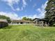 Spacious backyard featuring a lawn, wooden gazebo, and the exterior of the home, all under a beautiful blue sky at 539 Willow Dr, Danville, IN 46122