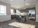 The kitchen features gray cabinetry, stainless appliances, an island with bar stools, and bright natural light at 5533 Tart Blvd, Indianapolis, IN 46239