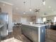Spacious kitchen area with an island and stainless steel appliances adjacent to the living area at 5533 Tart Blvd, Indianapolis, IN 46239