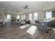 The open-concept living area features recessed lights, gray tones, and ample sunlight through large windows at 5533 Tart Blvd, Indianapolis, IN 46239