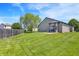 Spacious backyard featuring a well-manicured lawn, a fence, and mature trees at 5554 Jona Way, Bargersville, IN 46106