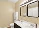 Well-lit bathroom offers double sinks with large mirrors, storage cabinet and tile flooring at 5554 Jona Way, Bargersville, IN 46106