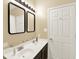Renovated bathroom boasts dual sinks, dark vanity, and modern lighting fixtures at 5554 Jona Way, Bargersville, IN 46106