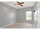 A cozy bedroom with a ceiling fan, a window, carpeted floor, and gray walls at 5554 Jona Way, Bargersville, IN 46106