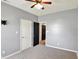 A cozy bedroom with a ceiling fan, carpeted floors, gray walls, and closet space at 5554 Jona Way, Bargersville, IN 46106