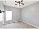 Neutral bedroom with carpet flooring features ceiling fan and large window at 5554 Jona Way, Bargersville, IN 46106