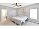 Neutral bedroom features a ceiling fan, carpet flooring, and natural light from the window at 5554 Jona Way, Bargersville, IN 46106