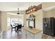 Open concept dining area with modern light fixture and stainless steel refrigerator at 5554 Jona Way, Bargersville, IN 46106