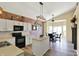 Bright kitchen featuring white cabinets, black appliances, and a charming exposed brick wall at 5554 Jona Way, Bargersville, IN 46106