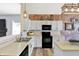 Well-designed kitchen with white cabinets, black appliances, and hardwood flooring at 5554 Jona Way, Bargersville, IN 46106