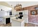 Bright kitchen featuring white cabinets, black appliances, and exposed brick wall at 5554 Jona Way, Bargersville, IN 46106