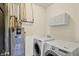 Convenient laundry room featuring modern washer and dryer with overhead cabinets at 5554 Jona Way, Bargersville, IN 46106
