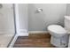 Clean bathroom features new shower, toilet, and wood floor at 616 W Michigan St, Greenfield, IN 46140