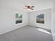 Sunlit bedroom boasts neutral walls, soft carpet, and dual windows at 616 W Michigan St, Greenfield, IN 46140