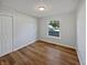 Bright bedroom with wood floors and natural light from a large window at 616 W Michigan St, Greenfield, IN 46140