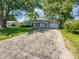 Well-maintained single story home featuring a well-kept lawn and a paved driveway at 616 W Michigan St, Greenfield, IN 46140