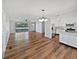Open concept living area with hardwood floors, a large sliding door, and access to the kitchen at 616 W Michigan St, Greenfield, IN 46140