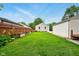 The backyard features a detached garage, wooden fence, and lush green lawn at 6176 Kingsley Dr, Indianapolis, IN 46220