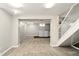 Partially finished basement includes laundry area, carpeted floor, and access to the stairs at 6176 Kingsley Dr, Indianapolis, IN 46220