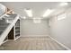 Spacious basement area with carpeted floors, shelving unit, and natural light from small windows at 6176 Kingsley Dr, Indianapolis, IN 46220