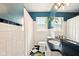 Charming bathroom with modern sink, white tile and black and white tiled floors at 6176 Kingsley Dr, Indianapolis, IN 46220