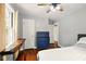 Bedroom with hardwood floors, white trim, and a vintage-style dresser at 6176 Kingsley Dr, Indianapolis, IN 46220