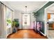 Bright dining room features hardwood floors, plants, and natural light at 6176 Kingsley Dr, Indianapolis, IN 46220