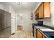 Practical kitchen with stainless steel appliances, a tile floor, and wooden cabinets at 6176 Kingsley Dr, Indianapolis, IN 46220